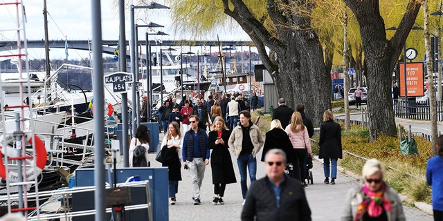 People taking a stroll Sunday in Stockholm, Sweden. (Fredrik SANDBERG / TT News Agency / AFP via Getty Images)