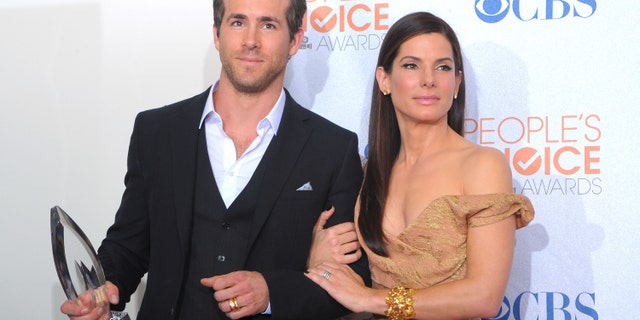 Ryan Reynolds (L) and actress Sandra Bullock pose with the Favorite Comedy Movie award for 'The Proposal' in the press room during the People's Choice Awards 2010.