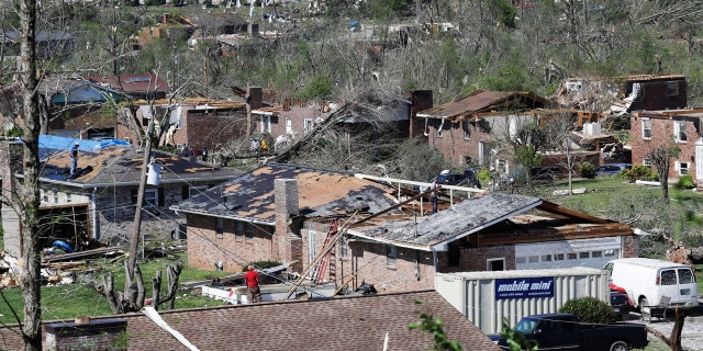 Damaged homes line a street Tuesday, April 14, 2020, in Chattanooga, Tenn. Tornadoes went through the area Sunday, April 12.
