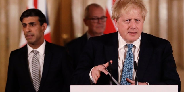 In this file photo dated Tuesday, March 17, 2020, Britain's Chancellor Rishi Sunak, left, and Prime Minister Boris Johnson arrive for a press briefing about the ongoing situation with the COVID-19 coronavirus outbreak.