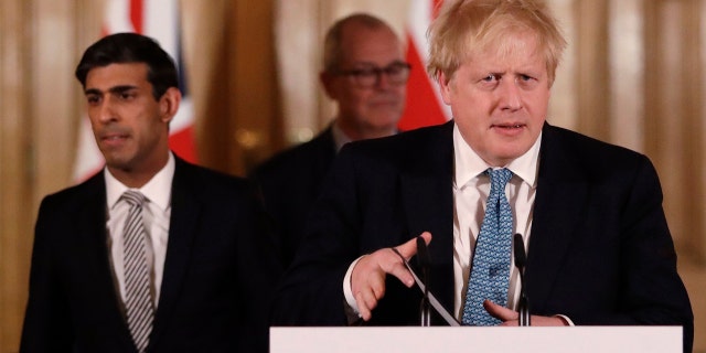 March 17, 2020: Britain's Chancellor Rishi Sunak, left, and Prime Minister Boris Johnson arrive for a press briefing about the ongoing situation with the COVID-19 coronavirus outbreak, inside 10 Downing Street in London.  (AP Photo/Matt Dunham)