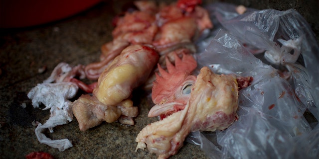 Chicken parts sit on the floor at a stall in the Shekou wet market in Shenzhen, China. (Brent Lewin/Bloomberg via Getty Images)