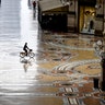 A cyclist rides along an empty Galleria Vittorio Emanuele II shopping arcade following Italy's lockdown due to the COVID-19 emergency, in Milan, Italy, April 30, 2020. 