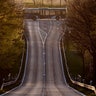 An empty bus crosses an empty road in Obernhain near Frankfurt, Germany, April 14, 2020. 