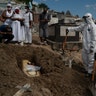 Taina dos Santos attends the burial of her mother Ana Maria, a 56-year-old nursing assistant who died from the coronavirus, in Rio de Janeiro, Brazil, April 28, 2020. 