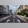 An Israeli man stands on his hands on an empty road during a lockdown following government measures to help stop the spread of the coronavirus, in Tel Aviv, Israel, April 8, 2020.