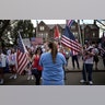 A woman who identified herself as a registered nurse in a local emergency room counterprotests in front of a demonstration to open up the state from the restrictions in place due to the new coronavirus, organized by the 3% United Patriots group, outside the Governor's Mansion, in St. Paul, Minnesota, April 25, 2020.