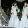 A cyclist wearing a protective mask to protect against coronavirus is reflected in the window of a wedding dress store with mannequins wearing face masks, in Zagreb, Croatia, April 23, 2020. 
