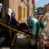 Enrique, a 92-year-old man is taken out of his home by medics to a waiting ambulance after he showed signs of possible coronavirus symptoms with serious breathing problems in Madrid, Spain, April 12, 2020.