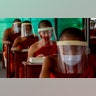 Novice Buddhist monks with protective masks and face shields, seated maintaining social distancing participate in a religious class at Molilokayaram Educational Institute in Bangkok, Thailand, April 15, 2020. 