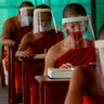 Novice Buddhist monks with protective masks and face shields, seated maintaining social distancing participate in a religious class at Molilokayaram Educational Institute in Bangkok, Thailand, April 15, 2020. 
