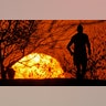 A man runs in a park to get some exercise as the sun sets during a stay-at-home order in Kansas City, Missouri, April 8, 2020.
