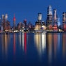 The lights of midtown Manhattan are reflected in the calm water of the Hudson River in New York City, April 15, 2020.