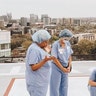 Nurses and surgical techs praying those impacted by CV19 on the roof of Vanderbilt University Medical Center