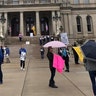 People protesting at the Michigan State Capitol.