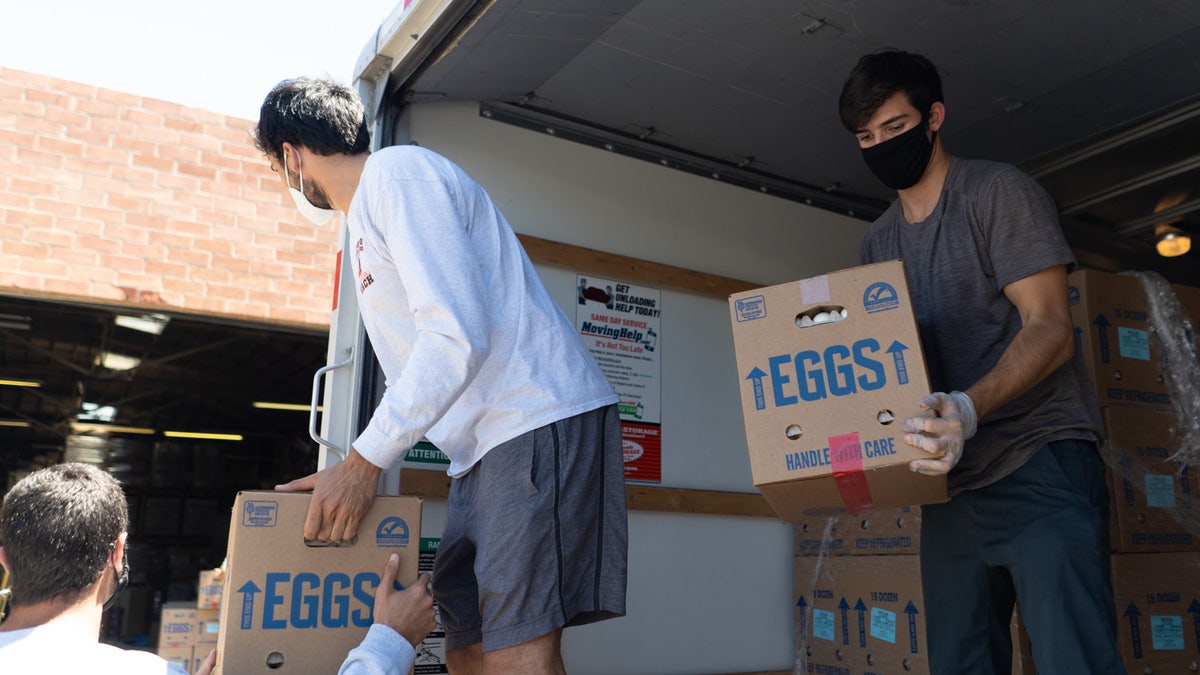 Members of Farmlink move a shipment of eggs from farms to three food banks in Los Angeles.