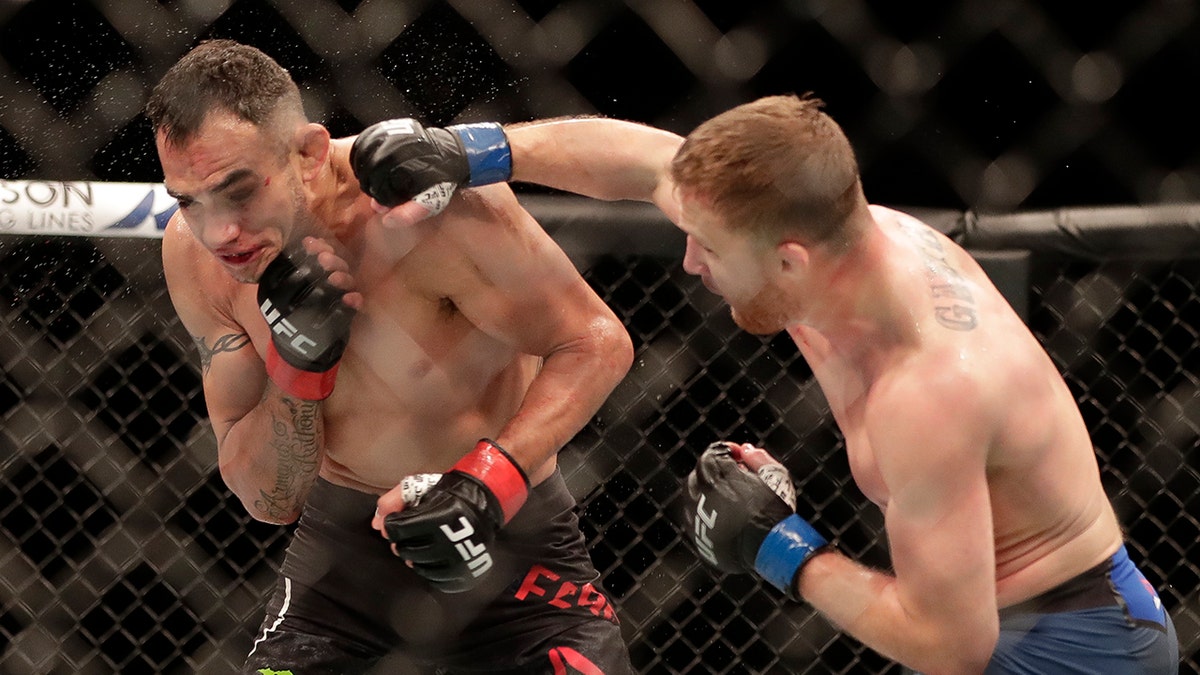 Justin Gaethje, right, punches Tony Ferguson during a UFC 249 mixed martial arts bout, Saturday, May 9, 2020, in Jacksonville, Fla. (AP Photo/John Raoux)