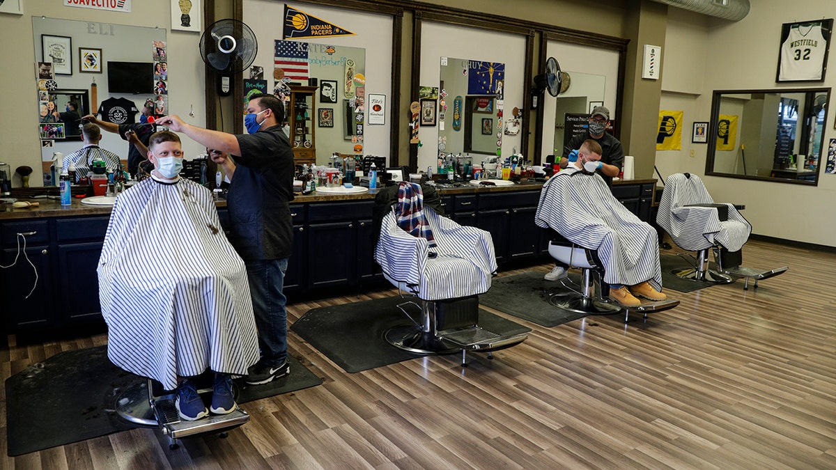 Barbershops in Indiana have been closed to prevent the spread of the coronavirus since March 25, and were allowed to open Monday by appointment and following social distancing guidelines. (AP Photo/Michael Conroy)