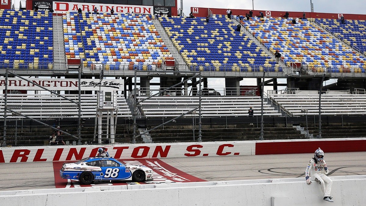 Kyle Busch sits on the pit wall after finishing second to Chase Briscoe (98) in the NASCAR Xfinity series auto race Thursday, May 21, 2020, in Darlington, S.C. (AP Photo/Brynn Anderson)