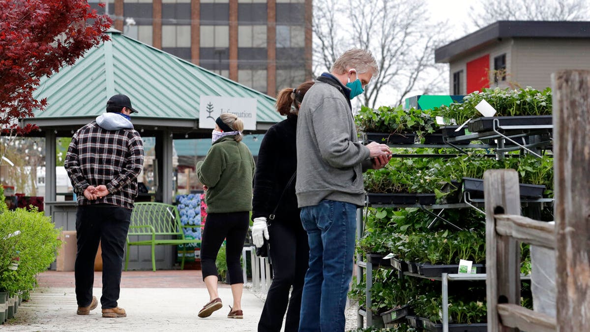 People shop at Lurvey Garden Center &amp; Landscape Suppy store in Des Plaines, Ill., April 30. Illinois garden centers and nurseries will reopen? May 1 by Gov. J.B. Pritzker. Lurvey Home and Garden opened its nursery yard and store on April 27.?