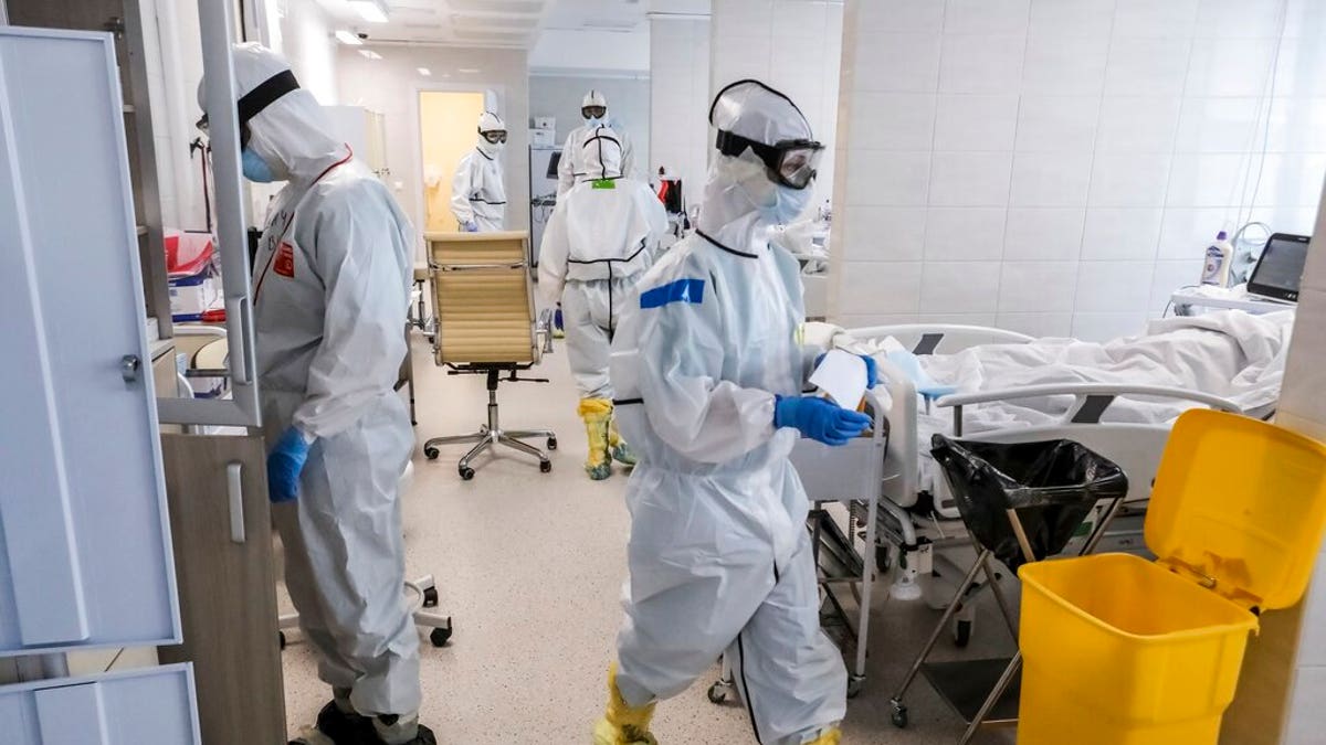 Doctors work inside the intensive care unit for people infected with the new coronavirus, at a hospital in Moscow, Russia. 