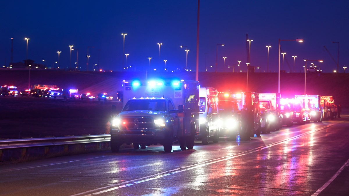 The procession of emergency vehicles for retired paramedic Paul Cary makes its way out of Denver International Airport on Sunday, May 3, 2020m, in Denver. Cary died from coronavirus after volunteering to help combat the pandemic in New York City. (Helen H. Richardson/The Denver Post via AP, Pool)