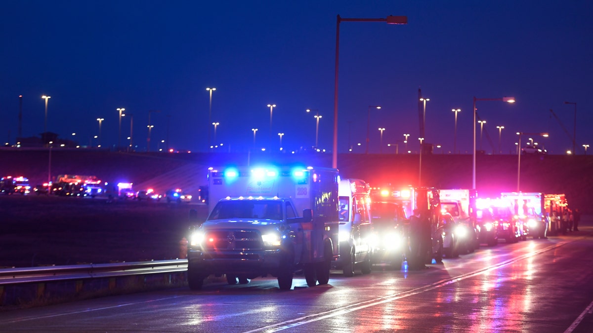The procession of emergency vehicles for retired paramedic Paul Cary makes its way out of Denver International Airport on Sunday, May 3, 2020m, in Denver. Cary died from coronavirus after volunteering to help combat the pandemic in New York City. (Helen H. Richardson/The Denver Post via AP, Pool)