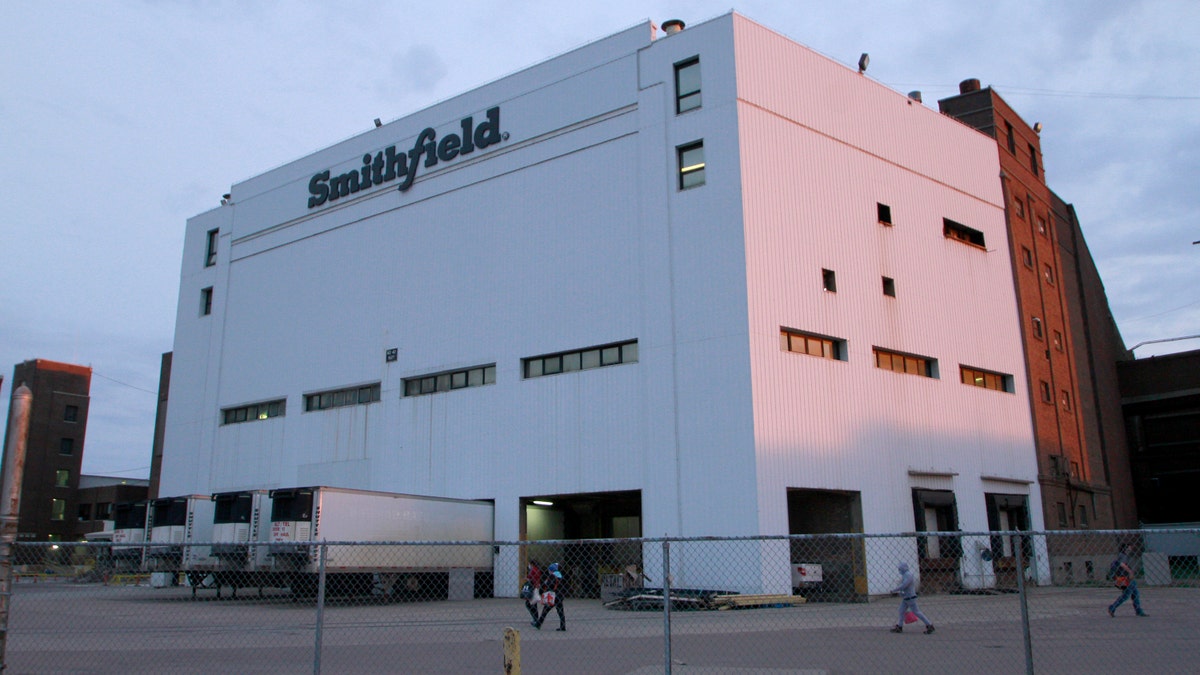 Employees of two departments at the Smithfield pork processing plant in Sioux Falls, S.D. report to work on Monday, May 4, 2020, as the plant moved to reopen after a coronavirus outbreak infected workers. (AP Photo/Stephen Groves)