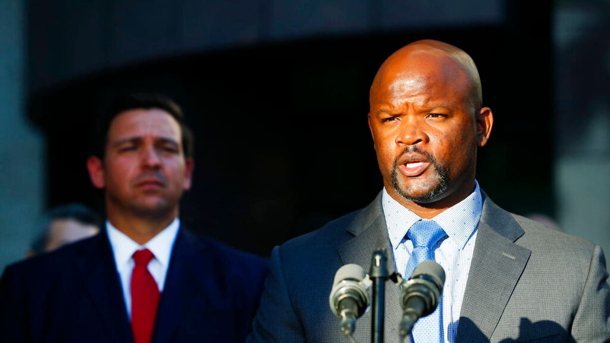 FILE: Acting Broward County sheriff Gregory Tony, right, speaks after being introduced by Florida Gov. 