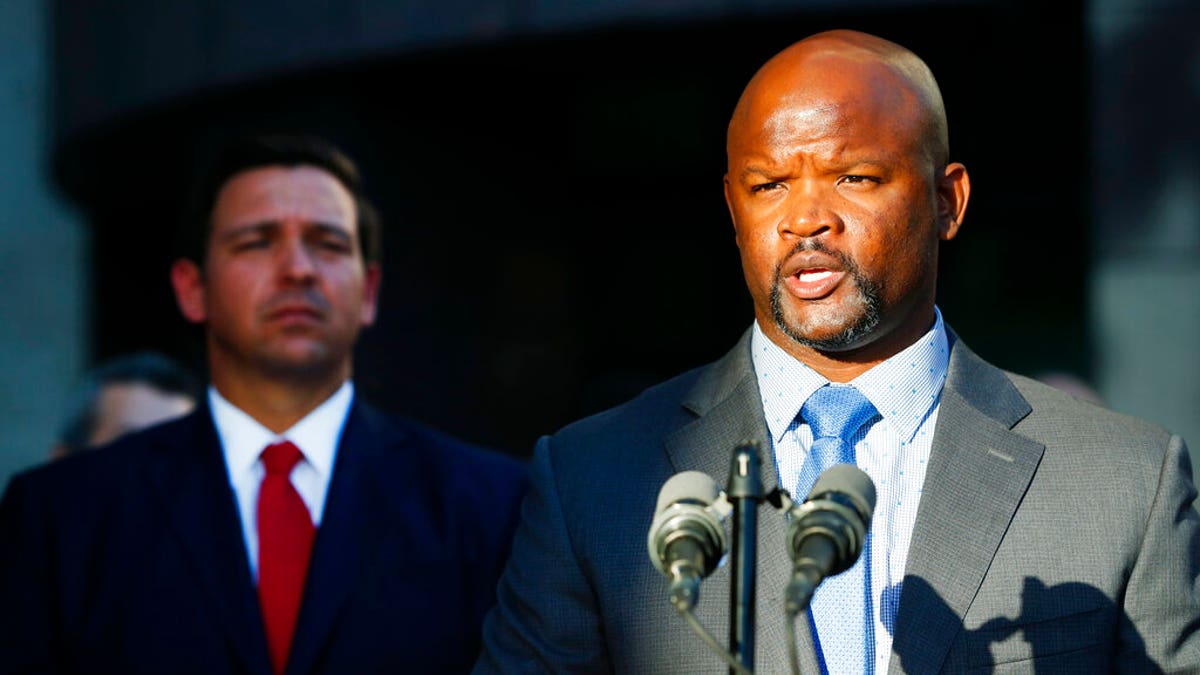 FILE: Acting Broward County sheriff Gregory Tony, right, speaks after being introduced by Florida Gov.