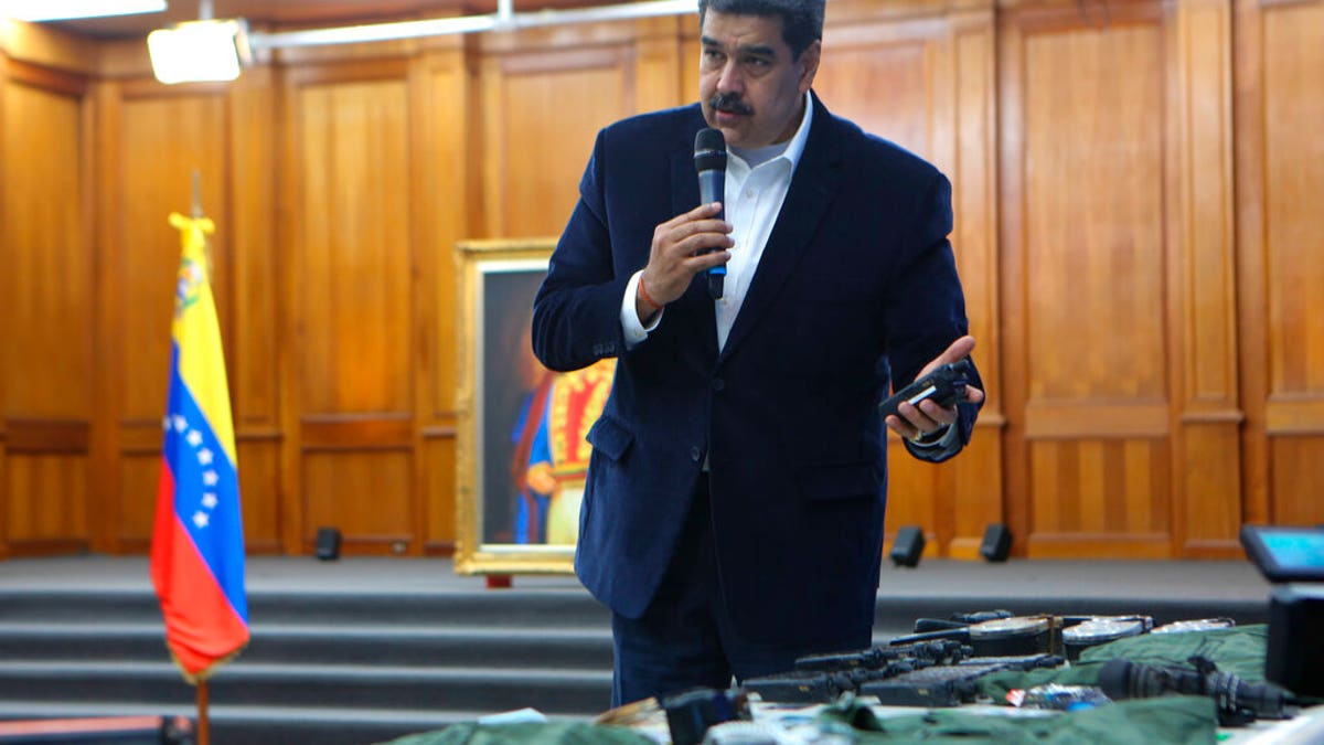 This photo released by the Venezuelan Miraflores presidential press office shows President Nicolas Maduro speaking over military equipment that he says was seized during an incursion into Venezuela, during his televised address from Miraflores in Caracas, Venezuela, Monday, May 4, 2020.