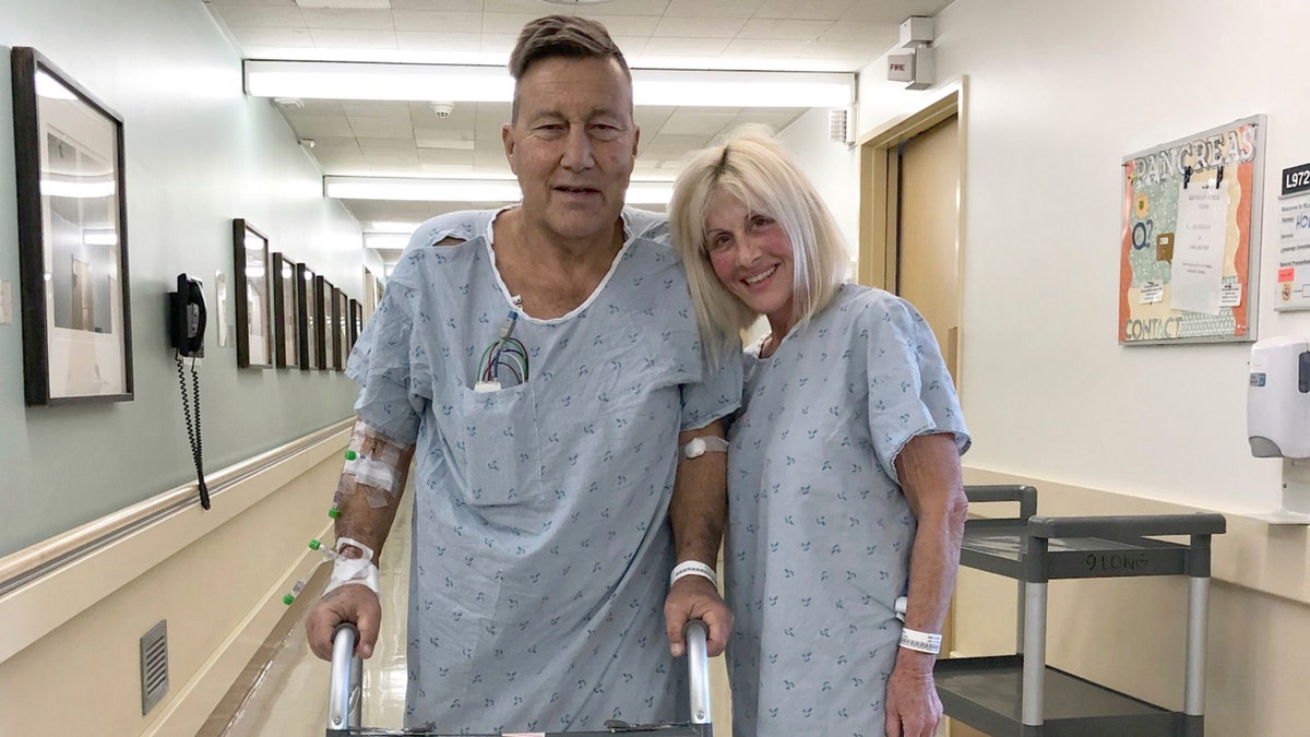 This April 1, 2020 photo provided by Herb Hoeptner shows him and his wife, Diane, at the UCSF hospital in San Francisco the day after surgery to donate one of her kidneys to him. Organ transplants have plummeted as COVID-19 swept through communities. But the team led by Dr. Chris Freise, interim transplant director at the University of California, San Francisco, allowed living kidney transplants for people like Herb Hoeptner, who was on the brink of needing dialysis. "When you have kidneys that have nothing left, you either go on dialysis or you die. That was much more of a concern to me than coronavirus," said Hoeptner.