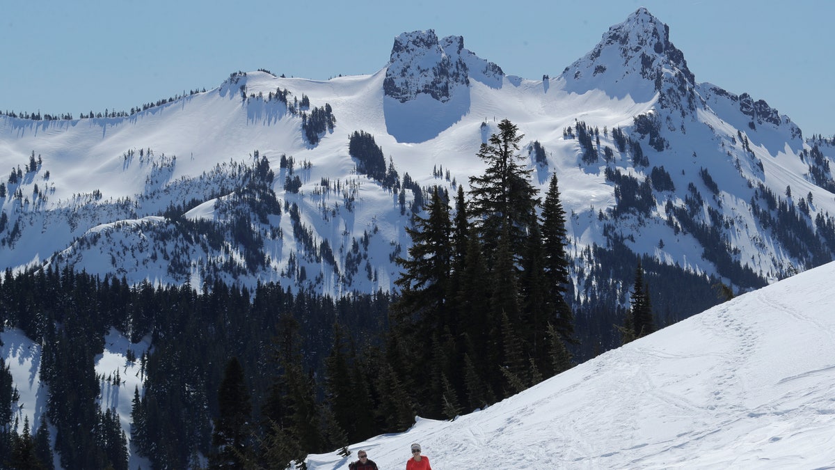 In this March 18 photo,, snowshoers head up a slope above Paradise at Mount Rainier National Park in Washington state. (AP Photo/Ted S. Warren, File)