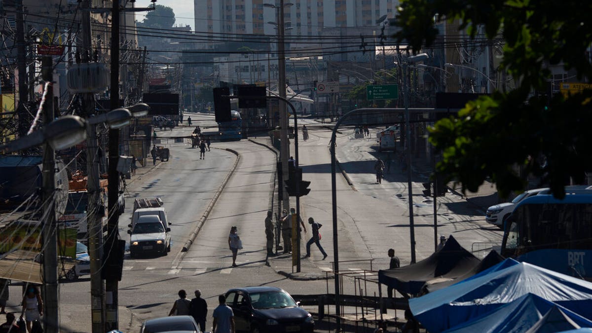 An avenue is partially empty amid increased restrictions on movements in an effort to curb the spread of the new coronavirus in the Madureira neighborhood of Rio de Janeiro, Brazil.