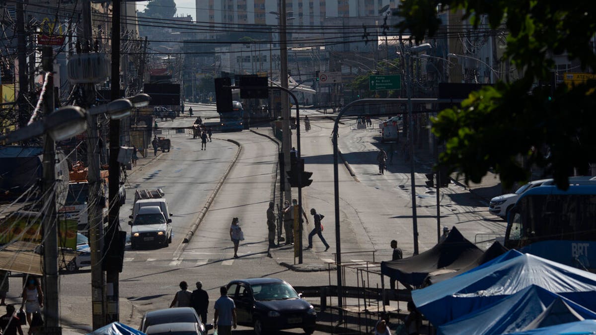 An avenue is partially empty amid increased restrictions on movements in an effort to curb the spread of the new coronavirus in the Madureira neighborhood of Rio de Janeiro, Brazil.