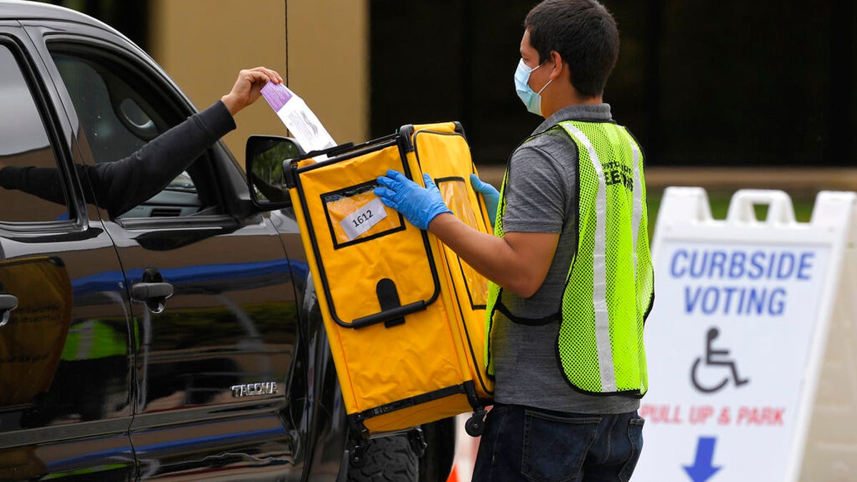 Voters drop off ballots in a special election for California's 25th Congressional District during the coronavirus outbreak, Tuesday, May 12, 2020, in Simi Valley, Calif. Republican Mike Garcia and Democrat Christy Smith are running for the seat after the resignation of Rep. Katie Hill, D-Calif. (AP Photo/Mark J. Terrill)