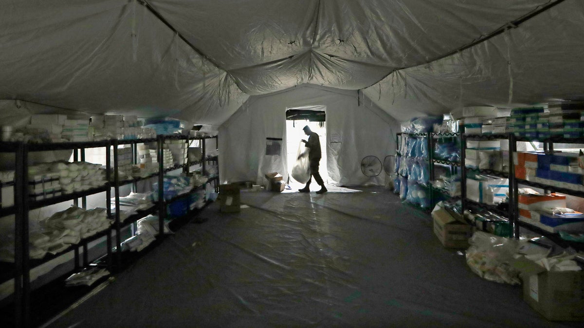 A U.S. Army soldier walking inside a mobile surgical unit being set up by soldiers from Fort Carson, Col., and Joint Base Lewis-McChord (JBLM), as part of a field hospital inside Seattle's CenturyLink Field Event Center this past March.