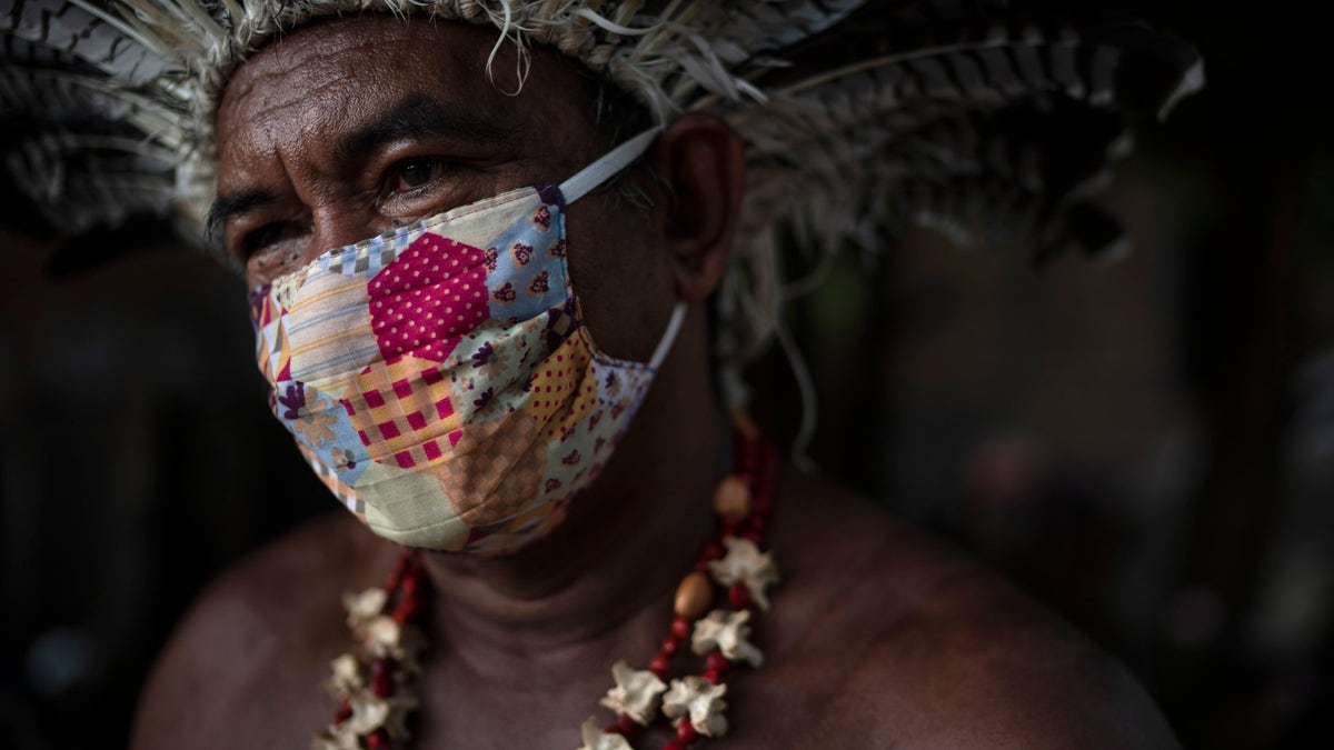 Pedro dos Santos, the leader of a community named Park of Indigenous Nations, poses for a photo, in Manaus, Brazil this May. Manaus' lack of the new coronavirus treatment prompted Pedro dos Santos to drink tea made of chicory root, garlic and lime to combat a high fever that lasted 10 days. (AP Photo/Felipe Dana)