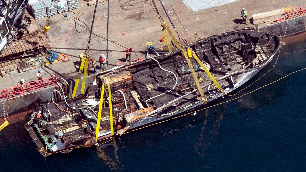 The burned hull of the dive boat Conception is brought to the surface by a salvage team in the Santa Barbara Channel off Santa Cruz Island in Southern California on Sept. 12, 2019. (Brian van der Brug/Los Angeles Times via AP, File)