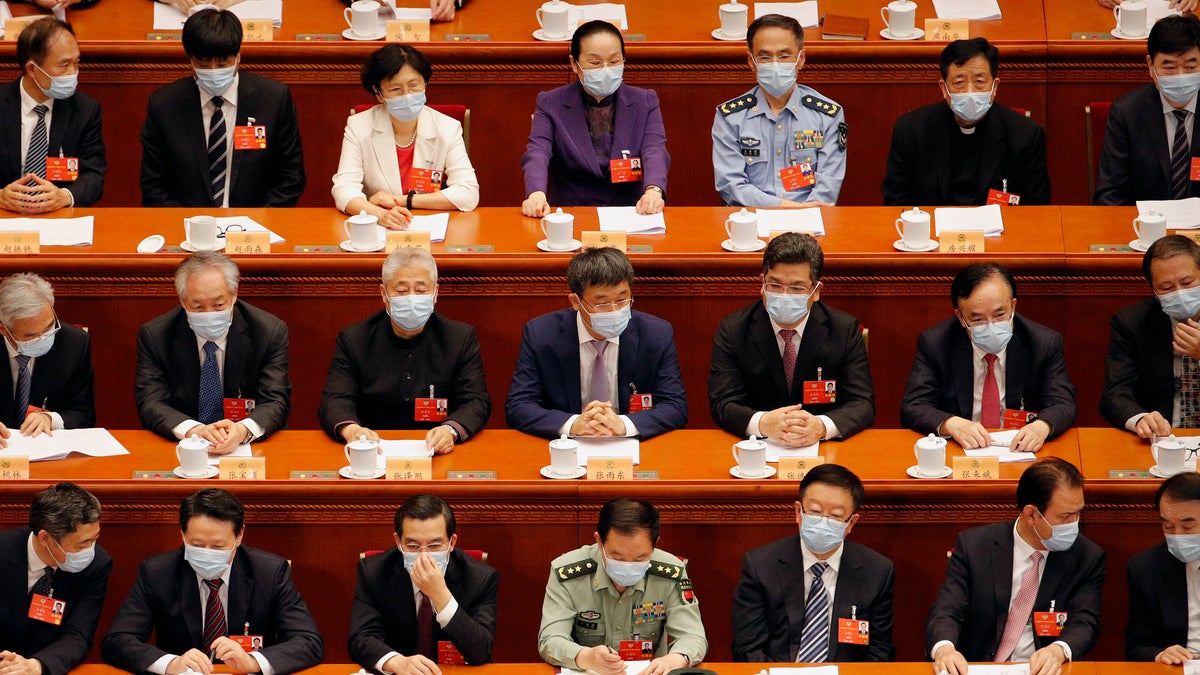 Delegates wearing face masks to protect against the spread of the new coronavirus wait for the start of the opening session of the Chinese People's Political Consultative Conference (CPPCC) at the Great Hall of the People in Beijing, Thursday, May 21, 2020. (AP Photo/Andy Wong, Pool)