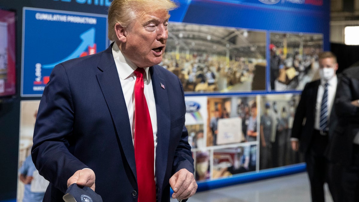 President Trump holds his protective face mask as he speaks while touring Ford's Rawsonville Components Plant that has been converted to making personal protection and medical equipment, Thursday, May 21, 2020, in Ypsilanti, Mich. (Associated Press)