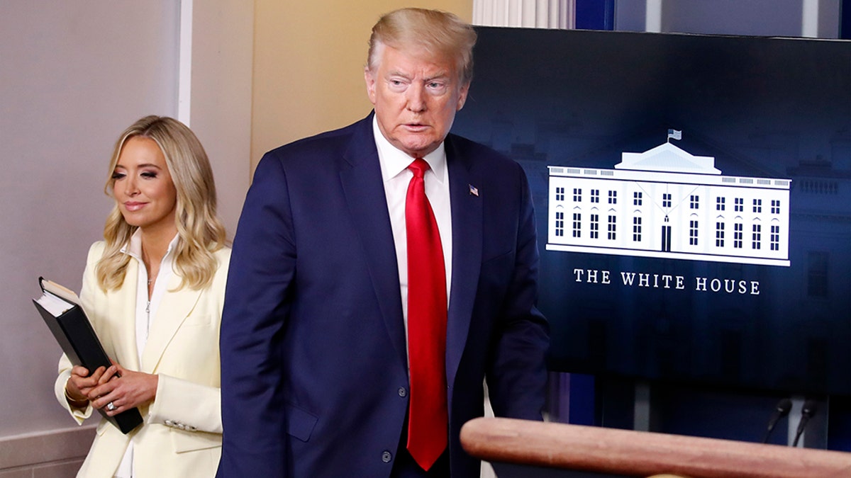 President Donald Trump arrives with press secretary Kayleigh McEnany to speak with reporters about the coronavirus at the White House on May 22, 2020. (AP Photo/Alex Brandon)