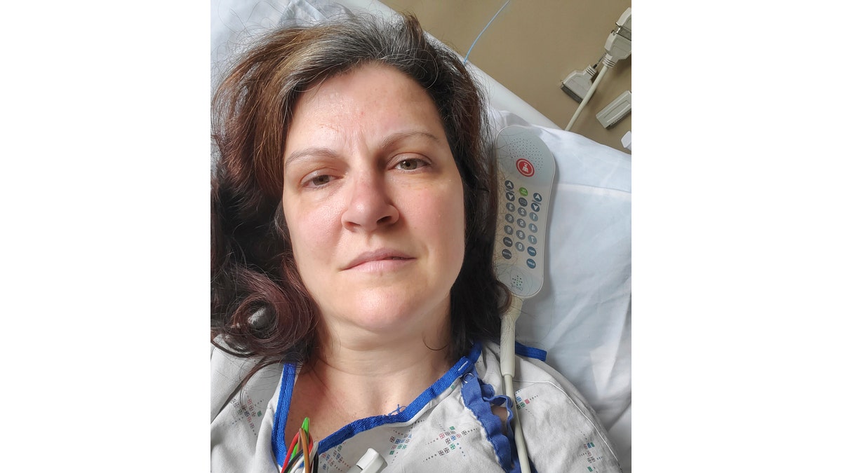This May 6, 2020 photo provided by Darlene Gildersleeve, 43, of Hopkinton, N.H. shows her at a Manchester, N.H. hospital. Gildersleeve thought she had recovered from COVID-19. Doctors said she just needed rest. And for several days, no one suspected her worsening symptoms were related — until a May 4 video call, when her physician heard her slurred speech and consulted a specialist. “You’ve had two strokes,’’ a neurologist told her at the hospital.
