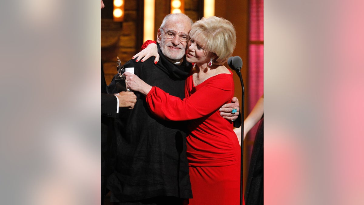 FILE -This June 12, 2011 file photo shows Larry Kramer, left, and Daryl Roth embracing after they won the Tony Award for Best Revival of a Play for 'The Normal Heart' during the 65th annual Tony Awards in New York. (AP Photo/Jeff Christensen, File)