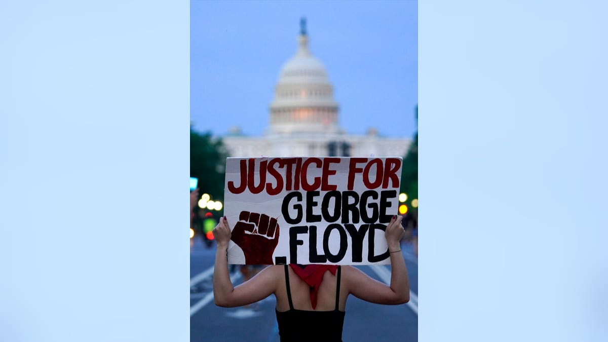 Demonstrators walk along Pennsylvania Avenue as they protest the death of George Floyd, a black man who died in police custody in Minneapolis, Friday, May 29, 2020, in Washington. (AP Photo/Evan Vucci)