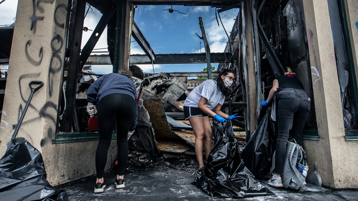 Pratt Volunteers clean up in Minneapolis, Saturday, May 30, 2020, following a night of unrest and protests in the death of George Floyd. Floyd died after being restrained by Minneapolis police officers on Memorial Day. (Khadejeh Nikouyeh/News &amp; Record via AP)