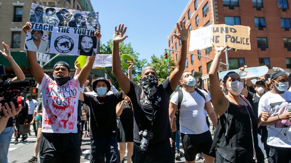 Protesters march through the streets of Harlem during a solidarity rally for George Floyd, Saturday, May 30, 2020, in New York. Floyd died after Minneapolis police officer Derek Chauvin pressed his knee into his neck for several minutes even after he stopped moving and pleading for air. (AP Photo/Mary Altaffer)