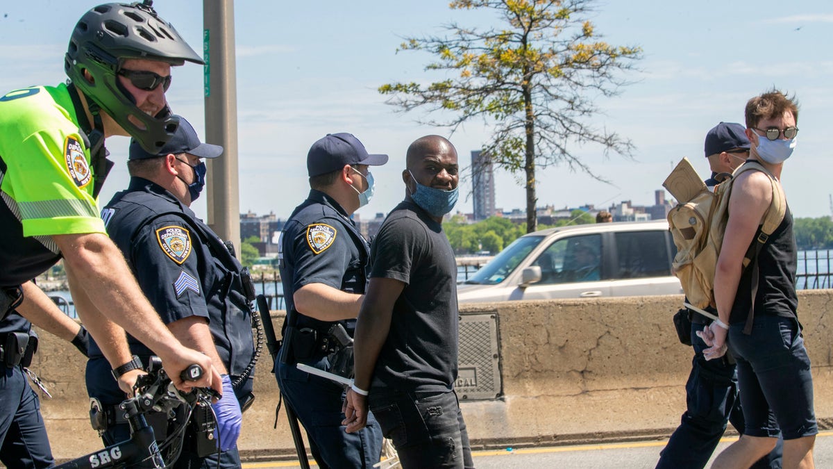 Protesters are arrested for blocking traffic on the F.D.R. while marching through Harlem during a solidarity rally for George Floyd, Saturday, May 30, 2020, in New York. Floyd died after Minneapolis police officer Derek Chauvin pressed his knee into his neck for several minutes even after he stopped moving and pleading for air. (AP Photo/Mary Altaffer)