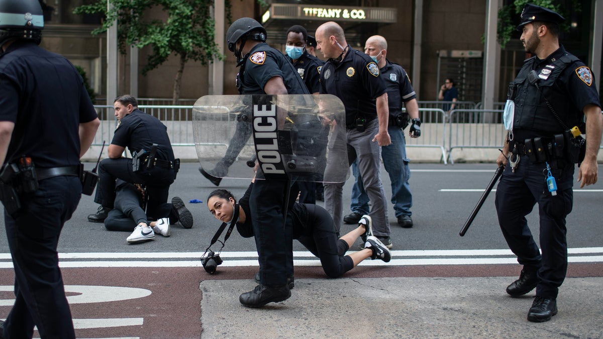 Police detain protesters in front of Trump Tower during a solidarity rally for George Floyd, Saturday, May 30, 2020, in New York. Demonstrators took to the streets of New York City to protest the death of Floyd, a black man who was killed in police custody in Minneapolis on May 25. (AP Photo/Wong Maye-E)