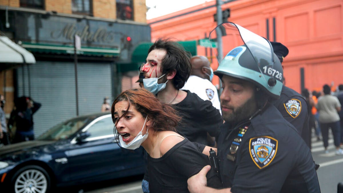 New York Police officers restrain protesters during a demonstration, Saturday, May 30, 2020, in the Brooklyn borough of New York. (AP Photo/Seth Wenig)